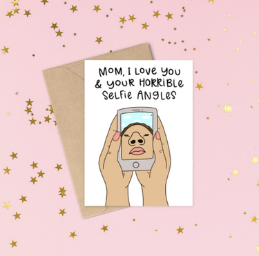 White card with words written in black that say Mom, I love you and your horrible selfie angels. With a picture of someone holding a cell phone and their nostrils and lips take up most of the picture. Great card for mom.
